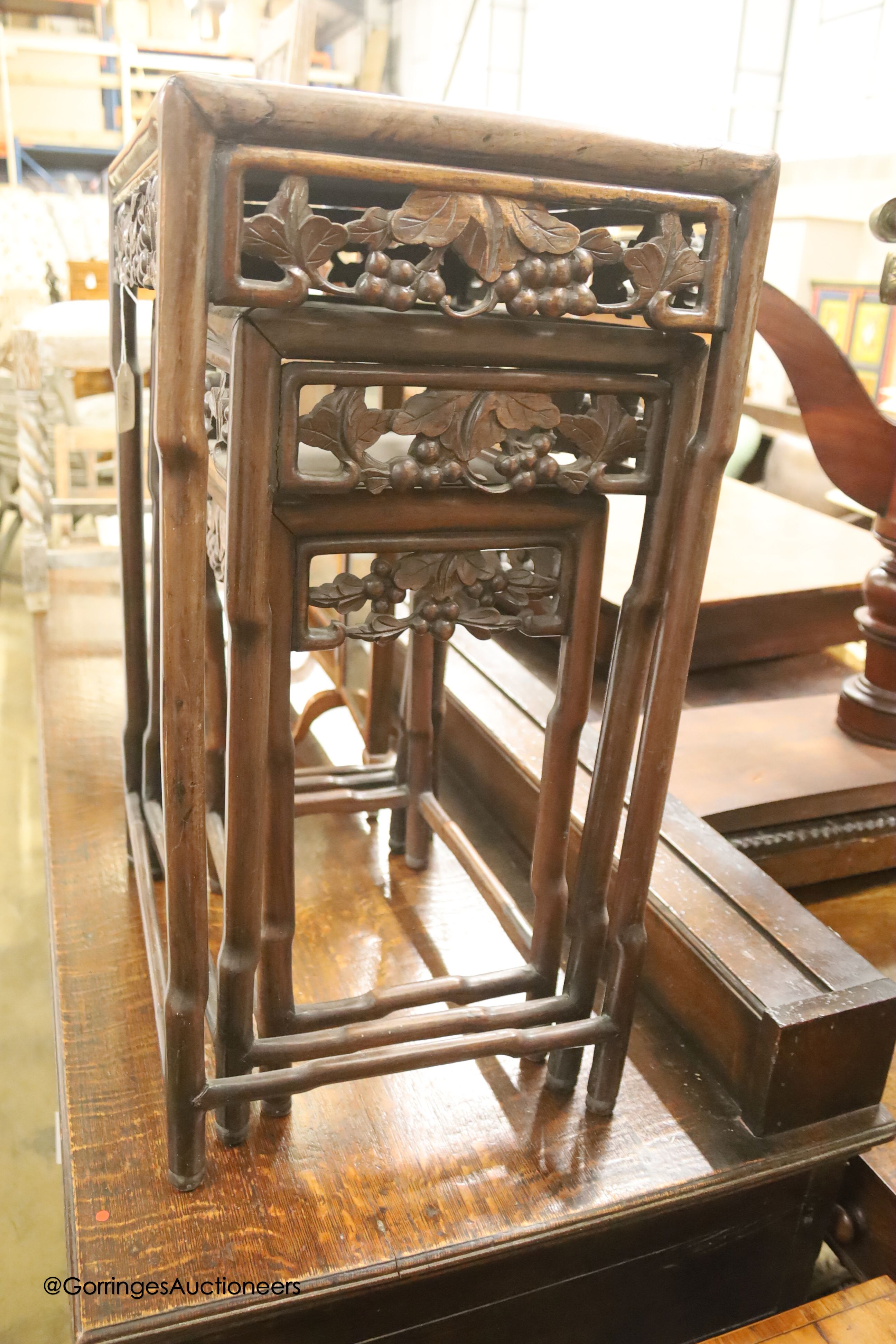 A nest of three Chinese rectangular carved hardwood tables, width 45cm, depth 33cm, height 54cm